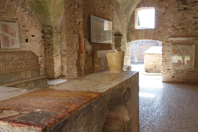 Ancient Ostia Antica Semi-Private Day Trip from Rome by Train with Guide - The Baths of Neptune and Ostia’s surviving mosaics