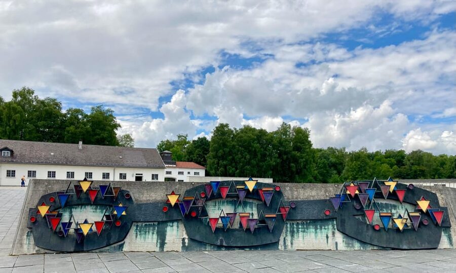 From Munich: Dachau Concentration Camp Private Tour by Train - Entering Through the Arbeit Macht Frei Gate