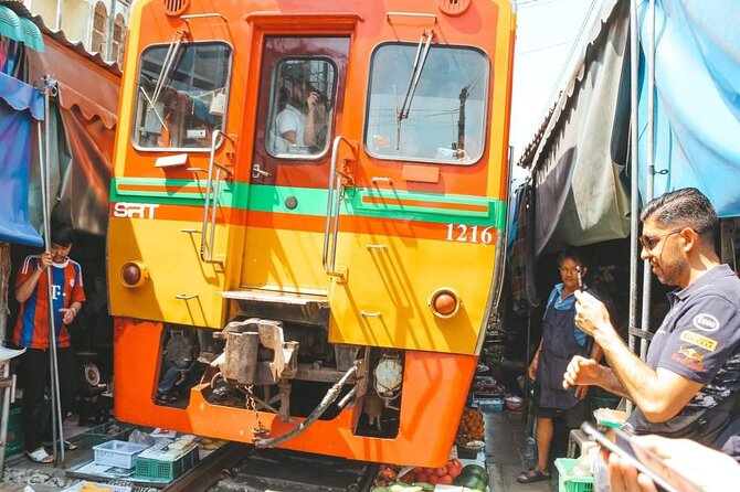 Maeklong Railway Market and Damnoen Saduak Floating Market Tour From Bangkok - Maeklong Railway Market and the umbrella pullback