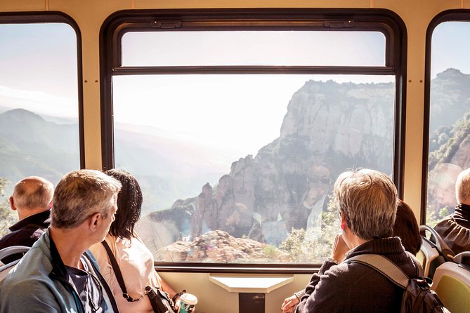 Passengers at the window of a mountain railway carriage