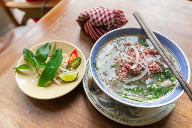 Small group Hanoi Street Food Tour with visit Train Street - Reaching Train Street after the food stops
